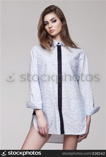 Beautiful young girl wearing shirt fashion on grey background