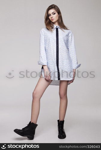 Beautiful young girl wearing shirt fashion on grey background