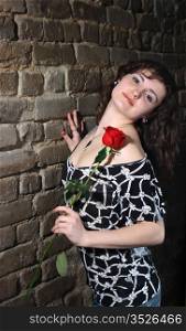 Beautiful young girl with a red rose, curly hairs