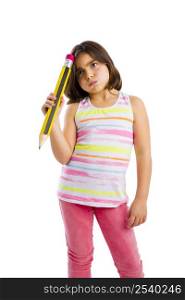 Beautiful young girl with a thinking expression while holding a big pencil