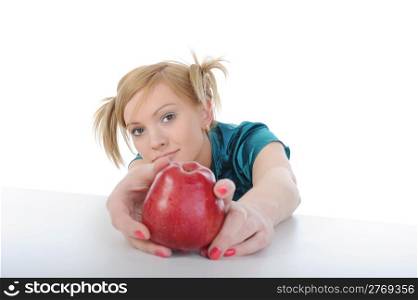 beautiful young girl with an apple on the table. Isolated on white background