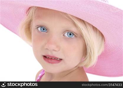 Beautiful young girl with blonde hair and bright blue eyes in a pink hat.