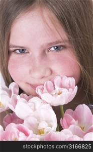 Beautiful young girl with pink tulips for mother on mother&acute;s day