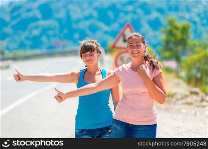 beautiful young girlfriends stopped passing car