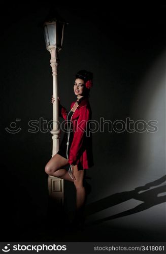 beautiful young glamorous woman with lightpole