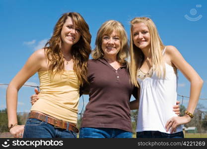 Beautiful young grandmother and granddaughters outdoors on their farm.