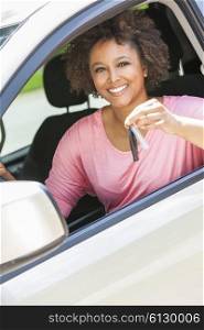 Beautiful young happy smiling mixed race black African American woman driving a car and holding the key