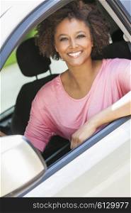 Beautiful young happy smiling mixed race black African American woman driving a car