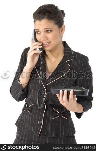 Beautiful young Hispanic business woman upset by phone call.