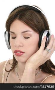 Beautiful young Hispanic woman listening to headphones.