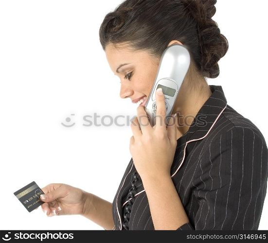 Beautiful young Hispanic woman on house phone with credit card. (not a real card)