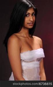 Beautiful young Indian woman draped in sheer white fabric