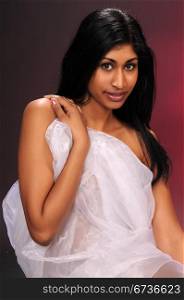 Beautiful young Indian woman draped in sheer white fabric