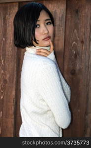 Beautiful young Japanese woman in a white knit sweater