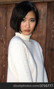 Beautiful young Japanese woman in a white knit sweater