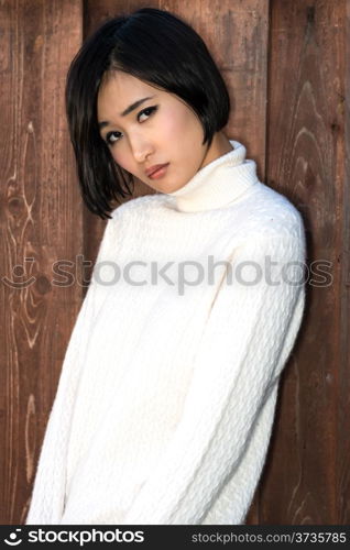 Beautiful young Japanese woman in a white knit sweater