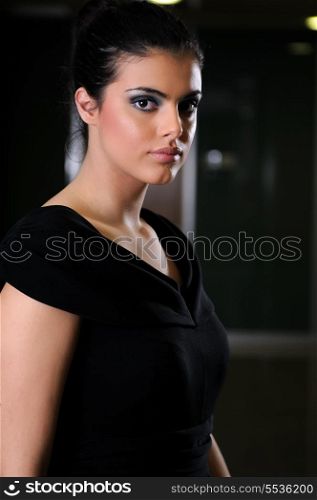beautiful young lady in black dress shoot from back