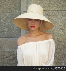Beautiful young lady in straw hat in the palace