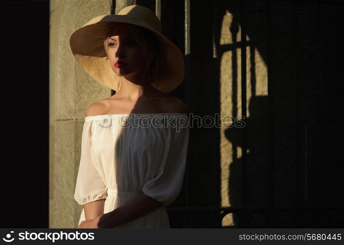 Beautiful young lady in straw hat in the palace