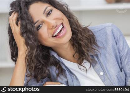 Beautiful young Latina Hispanic woman with perfect white teeth laughing &amp; relaxing at home