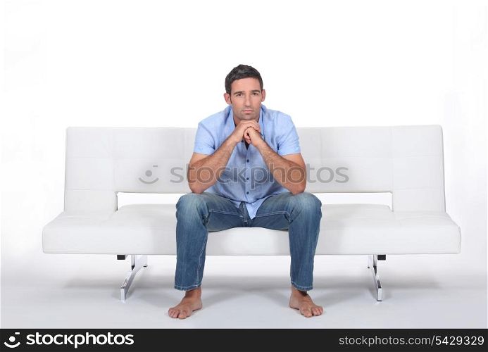 beautiful young man sitting on the sofa
