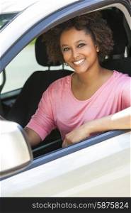 Beautiful young mixed race black African American woman driving a car