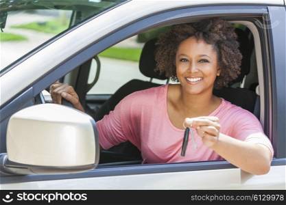 Beautiful young mixed race black African American woman driving a car and holding the key