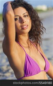 Beautiful young mixed race sexy Hispanic woman in bikini on a deserted tropical beach