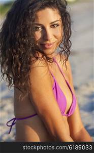 Beautiful young mixed race sexy Hispanic woman in bikini on a deserted tropical beach