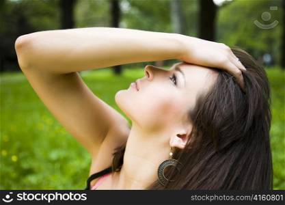 Beautiful young model on nature background