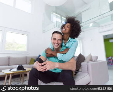 Beautiful young multiethnic couple hugging in their new apartment