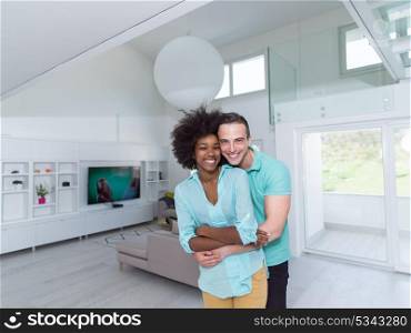 Beautiful young multiethnic couple hugging in their new apartment