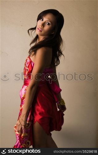 Beautiful young multiracial woman in a red dress
