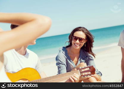 Beautiful young people with guitar on beach. Beautiful young people with guitar having fun on beach