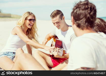 Beautiful young people with guitar on beach. Beautiful young people with guitar having fun on beach