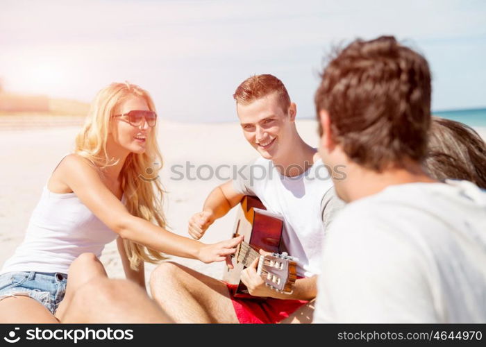 Beautiful young people with guitar on beach. Beautiful young people with guitar having fun on beach