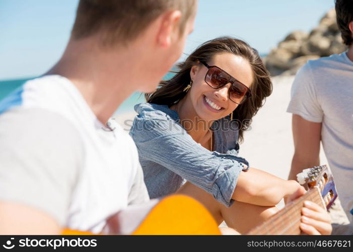 Beautiful young people with guitar on beach. Beautiful young people with guitar having fun on beach