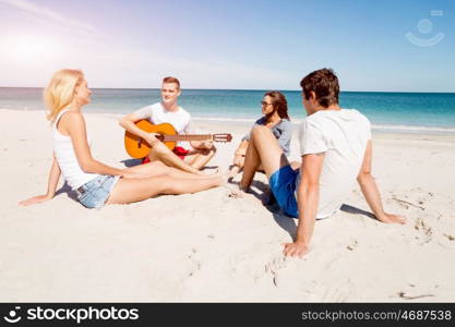 Beautiful young people with guitar on beach. Beautiful young people with guitar having fun on beach