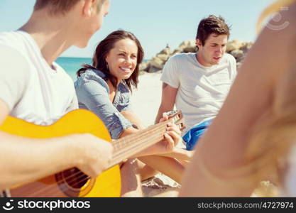 Beautiful young people with guitar on beach. Beautiful young people with guitar having fun on beach