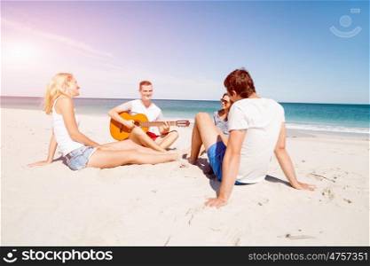 Beautiful young people with guitar on beach. Beautiful young people with guitar having fun on beach