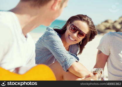 Beautiful young people with guitar on beach. Beautiful young people with guitar having fun on beach