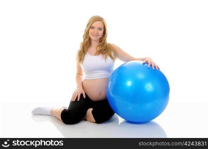 Beautiful young pregnant woman does sport exercises with a blue ball. Isolated on white background