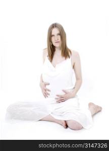 Beautiful Young Pregnant Woman In White Over White.