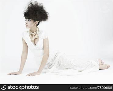 beautiful young pretty elf. Modern portrait of woman with stylish hair-dressing. Sexy caucasian model with black hair pose in photography studio on white background