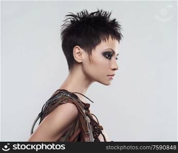 beautiful young pretty lady. Classic portrait of woman with stylish hair-dressing. Sexy caucasian model with black hair pose in photography studio on grey background