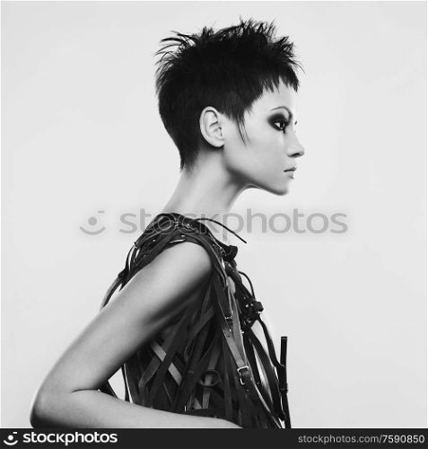 beautiful young pretty lady. Classic portrait of woman with stylish hair-dressing. Sexy caucasian model with black hair pose in photography studio on grey background