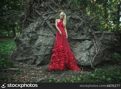 Beautiful young red queen in the old forest