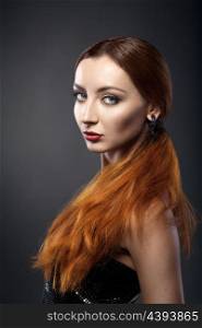 beautiful young redhead woman isolated on dark background