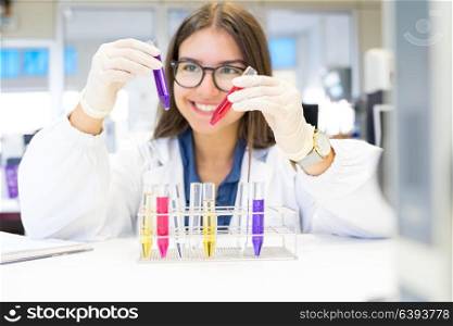 Beautiful young scientist working at the laboratory