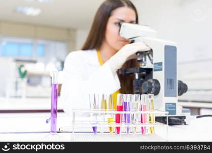 Beautiful young scientist working at the laboratory